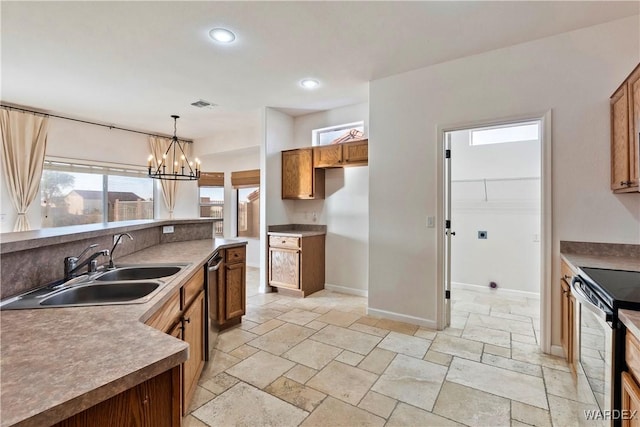 kitchen featuring brown cabinets, stainless steel appliances, and decorative light fixtures