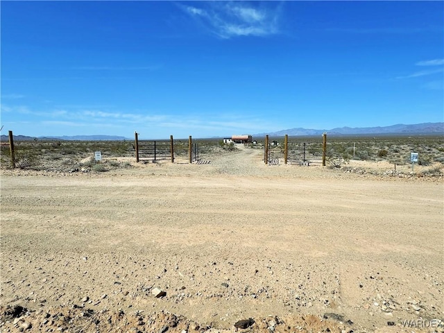 exterior space featuring a rural view, fence, and a mountain view