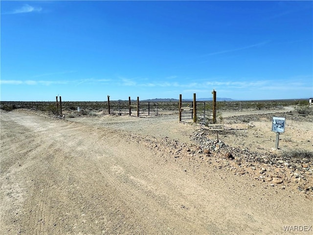 view of yard featuring a rural view and fence