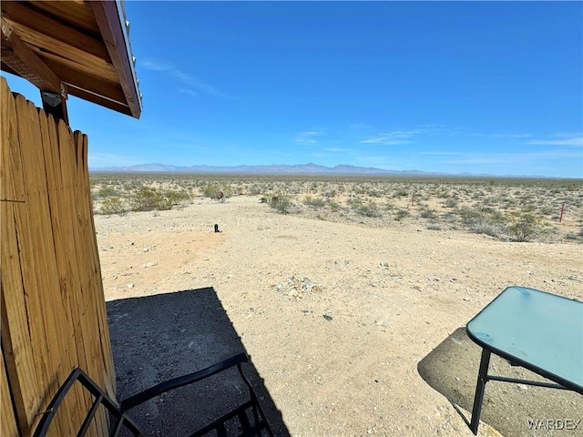 view of yard featuring a mountain view and view of desert