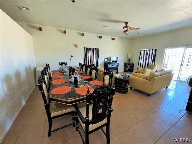 dining area featuring light tile patterned floors, visible vents, and a ceiling fan