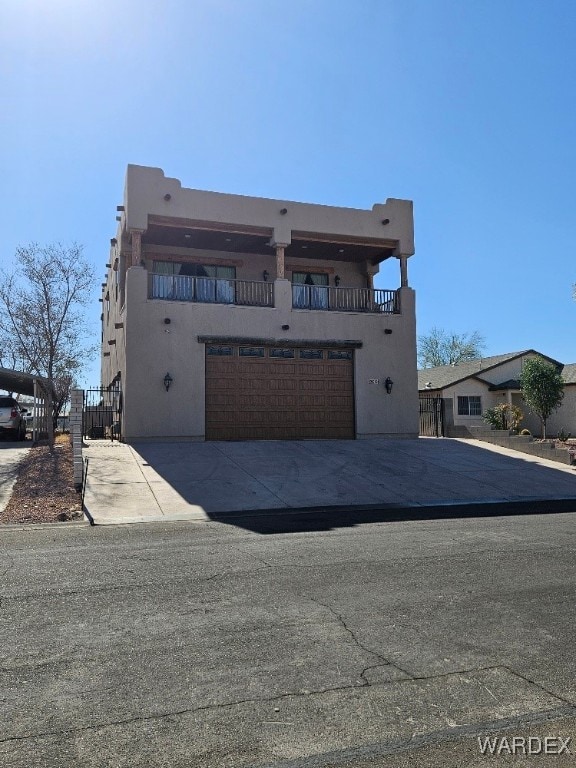 southwest-style home featuring driveway, an attached garage, and stucco siding