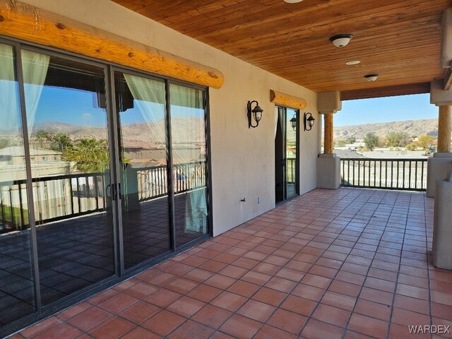 view of patio / terrace featuring a mountain view and a balcony