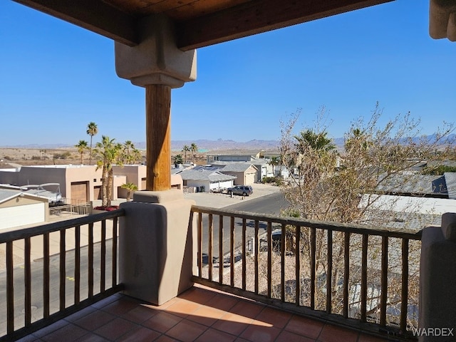 balcony featuring a residential view and a mountain view