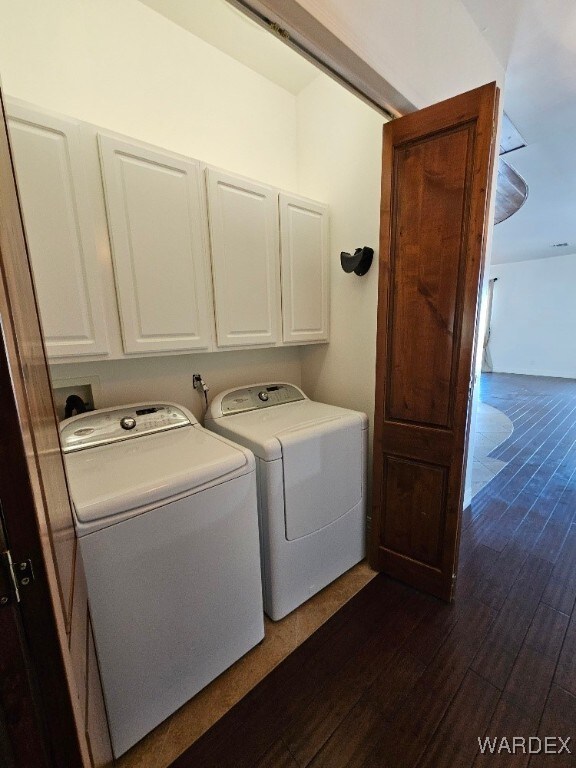 laundry area with cabinet space, dark wood-style flooring, and washer and dryer