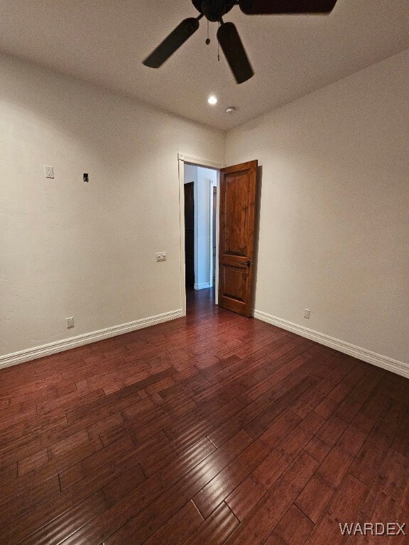 unfurnished room featuring recessed lighting, dark wood finished floors, baseboards, and ceiling fan