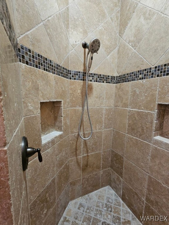 bathroom with tiled shower