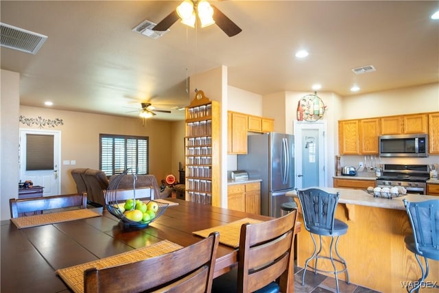 dining space with ceiling fan, visible vents, and recessed lighting