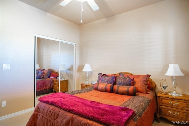 carpeted bedroom with a closet, a ceiling fan, and baseboards