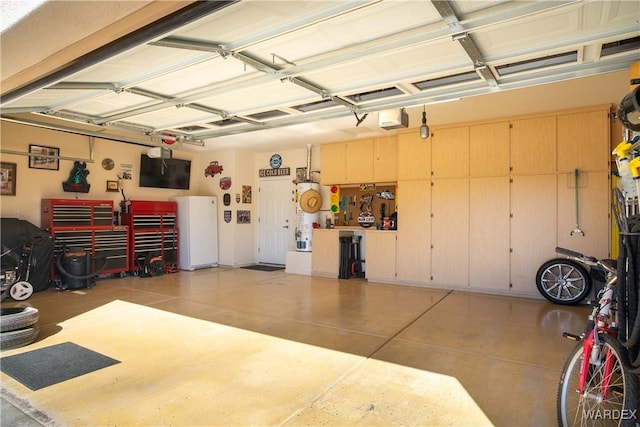 garage featuring a garage door opener and a workshop area