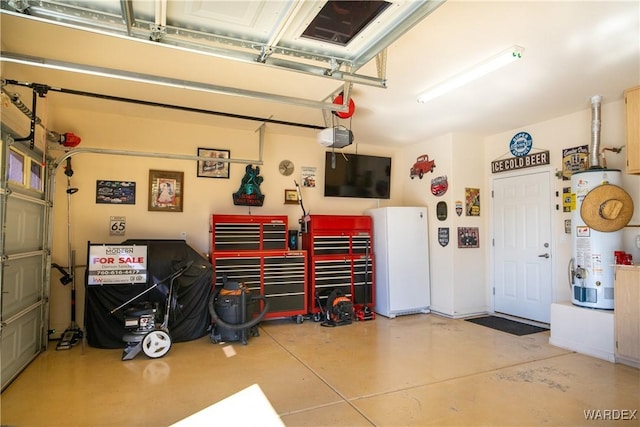 garage with a garage door opener, freestanding refrigerator, and water heater