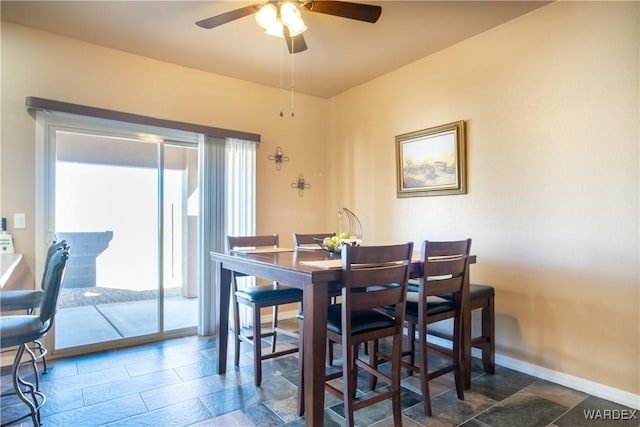 dining room featuring baseboards and a ceiling fan