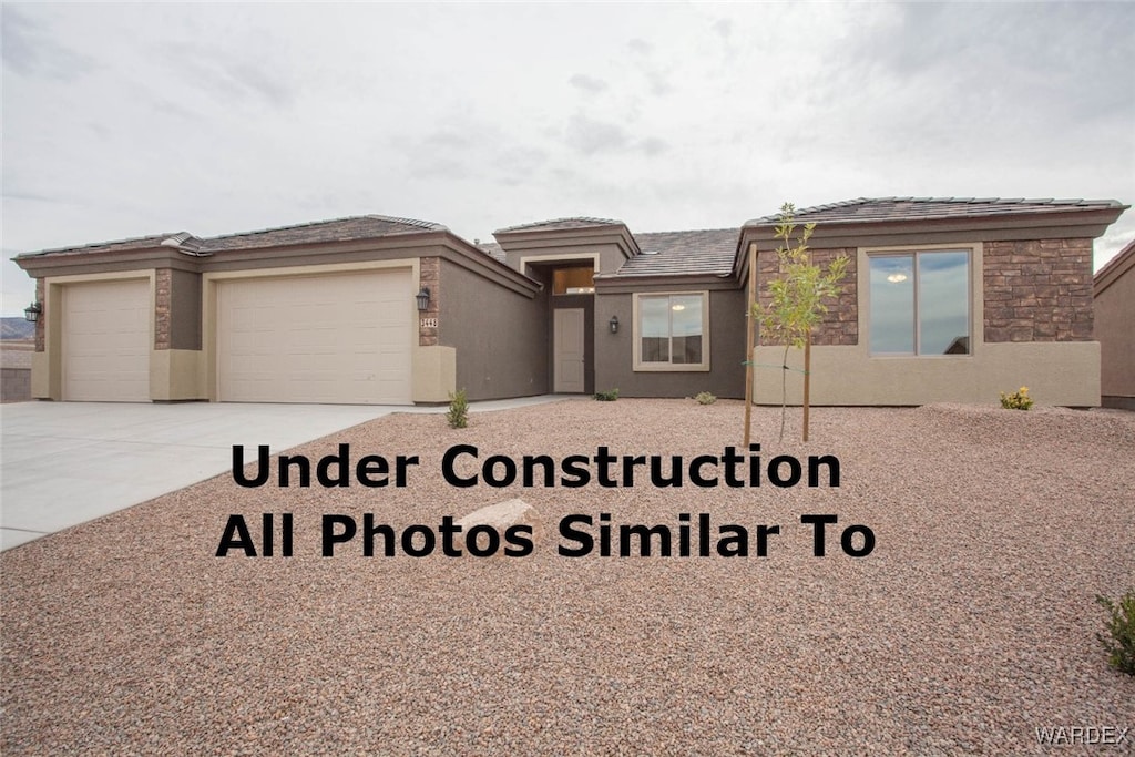 view of front of property with driveway, an attached garage, and stucco siding