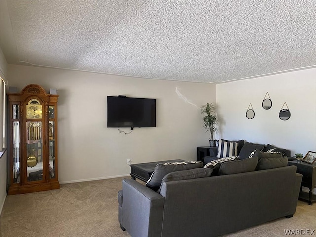 living area featuring light carpet, a textured ceiling, and baseboards