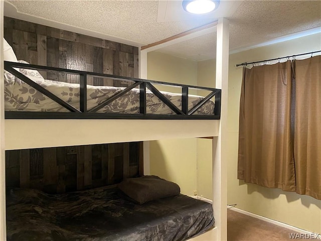 carpeted bedroom with a textured ceiling