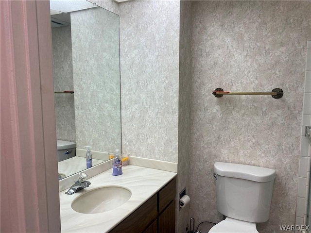 bathroom with vanity and toilet