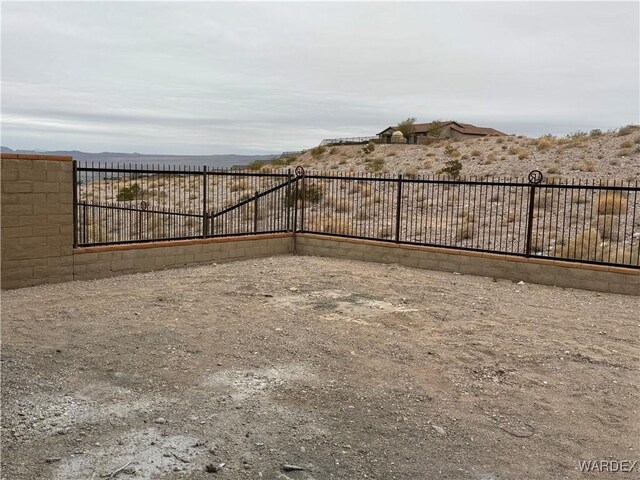 view of gate featuring fence