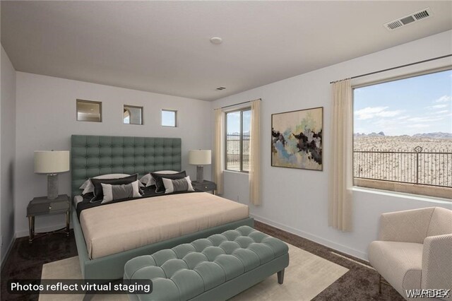 bedroom with a mountain view, visible vents, and baseboards