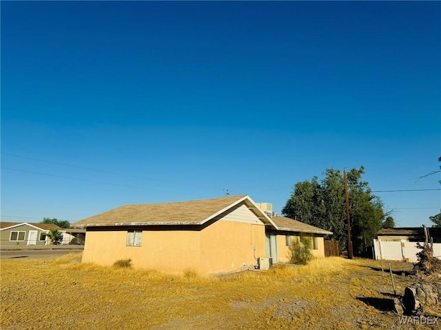 view of side of property with stucco siding