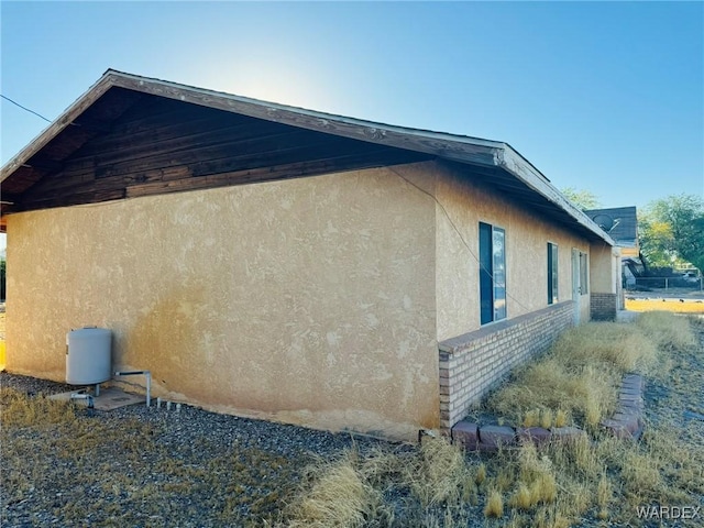 view of home's exterior with brick siding and stucco siding