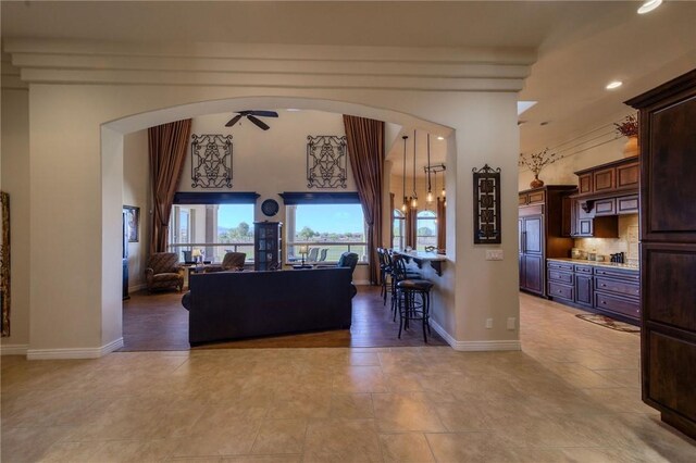 25 Torrey Pines Dr, Mohave Valley, AZ 86440 - living room featuring arched walkways, a ceiling fan, recessed lighting, baseboards, and light tile patterned flooring