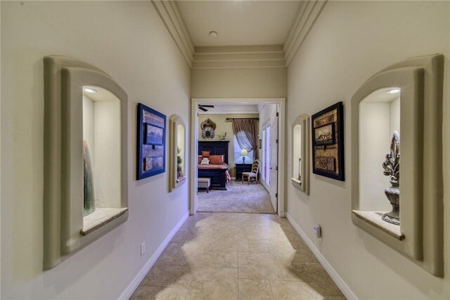 25 Torrey Pines Dr, Mohave Valley, AZ 86440 - hallway with baseboards, arched walkways, ornamental molding, and light stone finish flooring