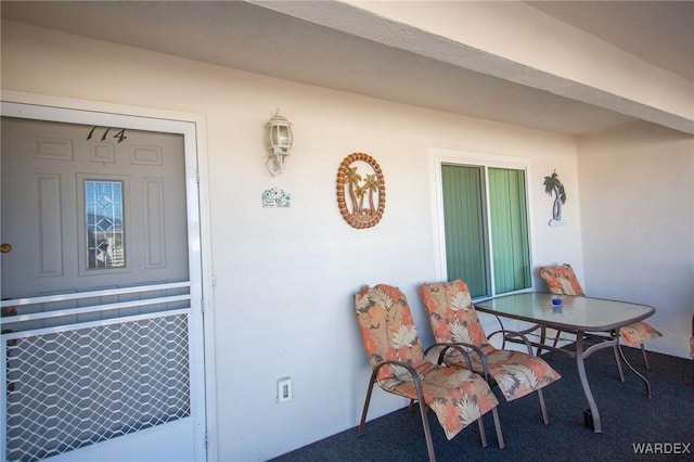 entrance to property with stucco siding