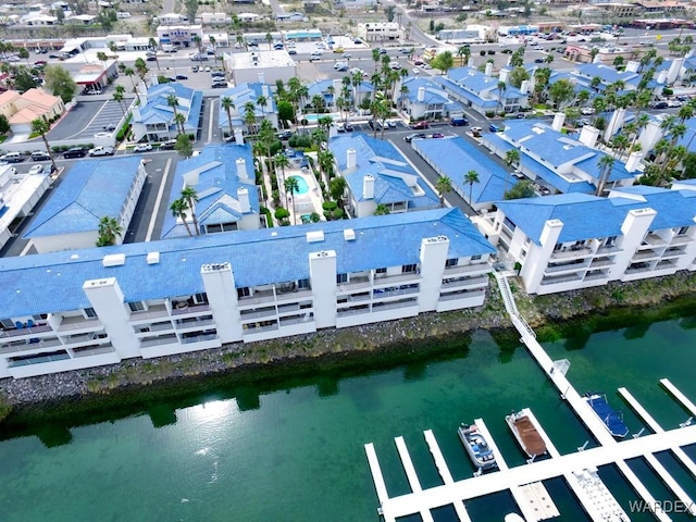 drone / aerial view featuring a residential view and a water view