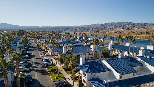 drone / aerial view with a residential view and a water and mountain view