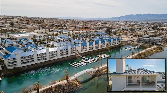 birds eye view of property featuring a water and mountain view