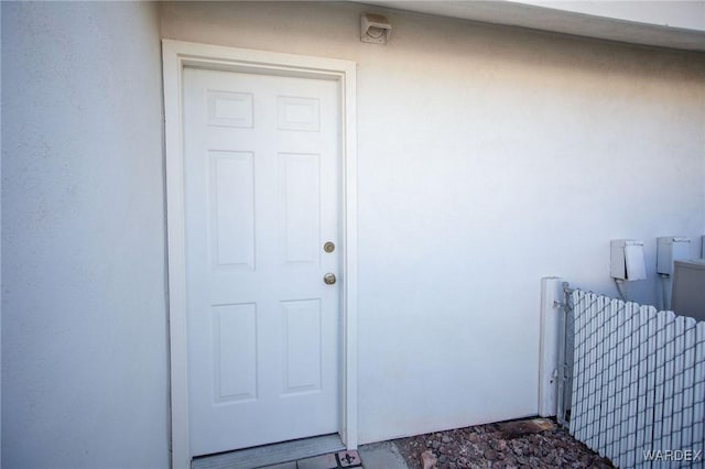 doorway to property with stucco siding