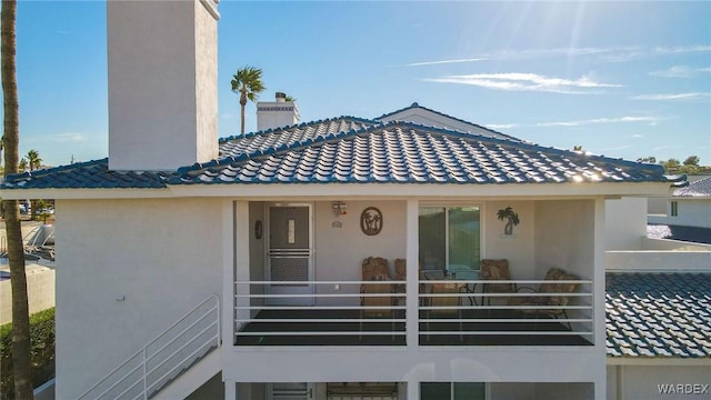 view of front of property with a balcony and stucco siding