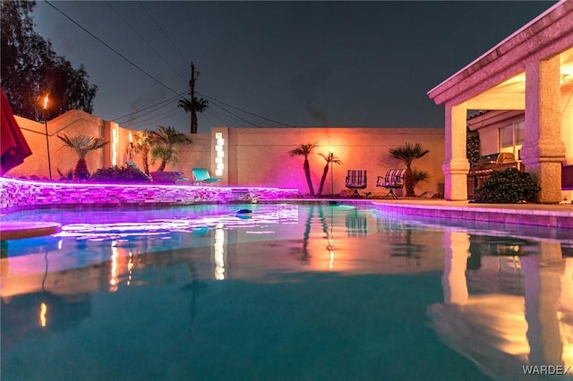 pool at twilight featuring an outdoor pool