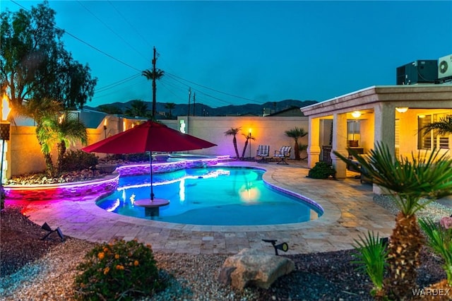 outdoor pool with a patio area and fence