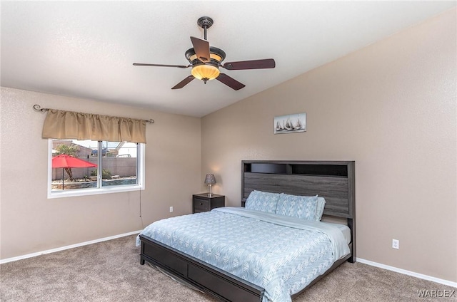 bedroom featuring baseboards, a ceiling fan, carpet, and lofted ceiling