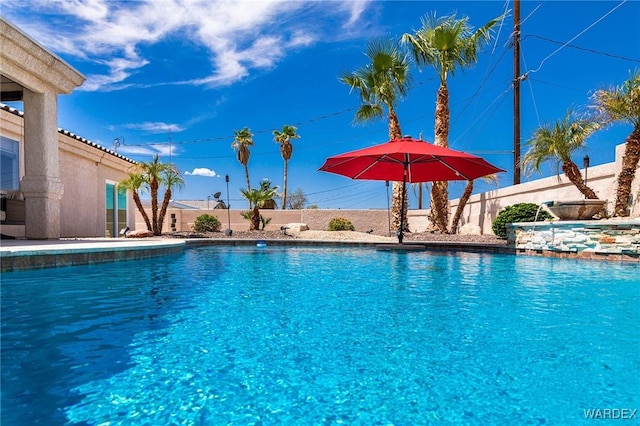 view of pool with a fenced in pool and fence