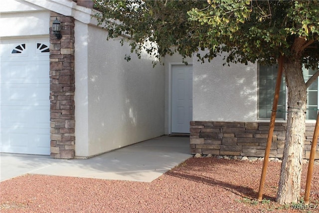 doorway to property with stone siding and stucco siding