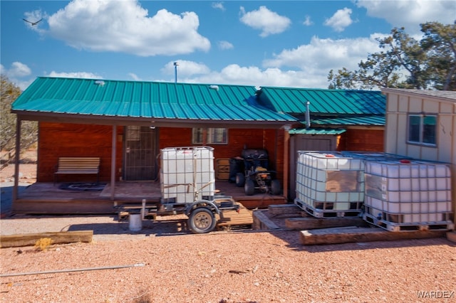 rear view of property with metal roof