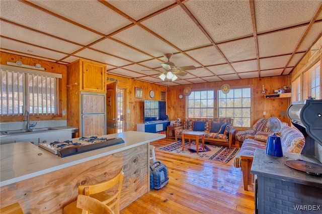 kitchen with plenty of natural light, paneled refrigerator, white gas cooktop, and a sink