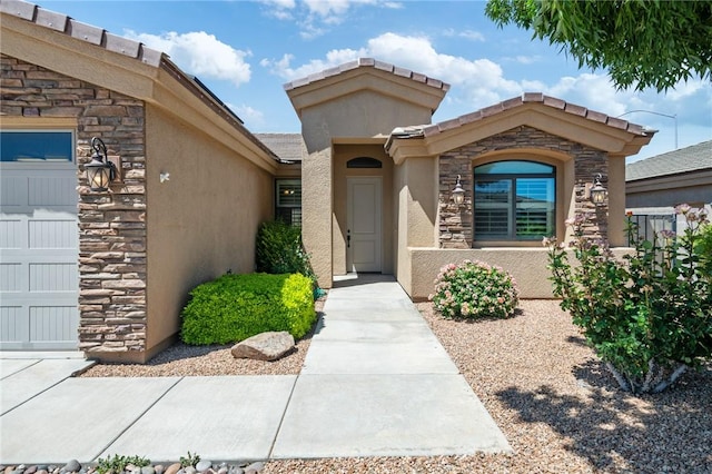 1999 Alan Ladd Dr, Kingman, AZ 86409 - doorway to property with stucco siding, stone siding, and a garage