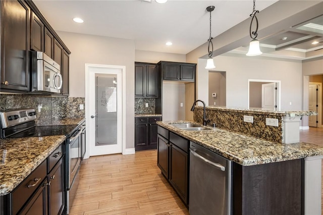 1999 Alan Ladd Dr, Kingman, AZ 86409 - kitchen featuring stainless steel appliances, a sink, light wood finished floors, backsplash, and recessed lighting