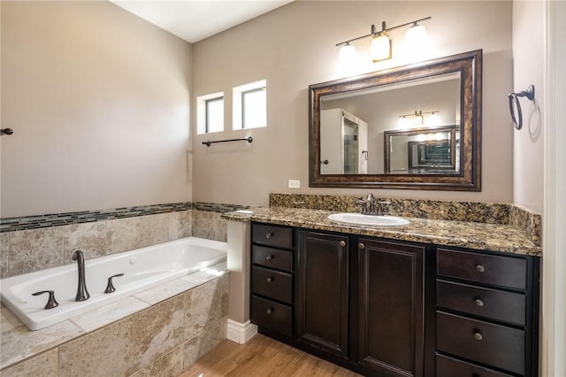 1999 Alan Ladd Dr, Kingman, AZ 86409 - full bath with a garden tub, vanity, and wood finished floors