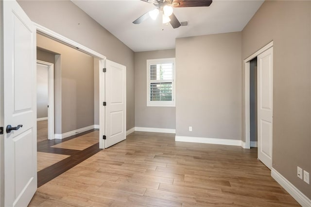 1999 Alan Ladd Dr, Kingman, AZ 86409 - unfurnished bedroom featuring baseboards, light wood-style flooring, and a ceiling fan