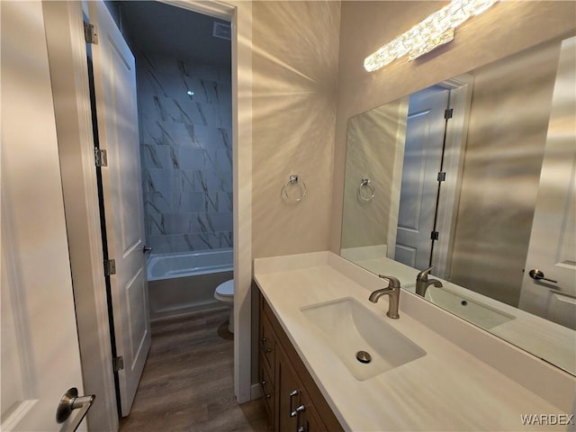 full bathroom with wood finished floors, vanity, and toilet