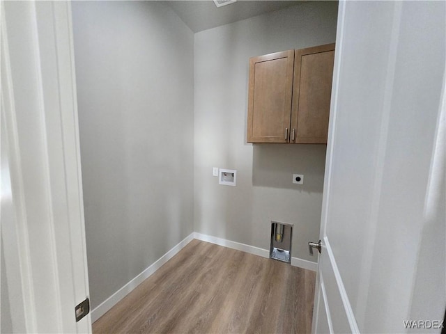 laundry room featuring hookup for a washing machine, cabinet space, light wood-style flooring, electric dryer hookup, and baseboards