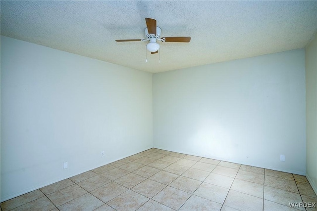 unfurnished room featuring ceiling fan, a textured ceiling, and light tile patterned floors