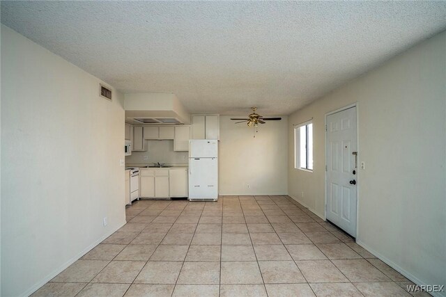 kitchen featuring light tile patterned floors, visible vents, a ceiling fan, white cabinets, and white appliances