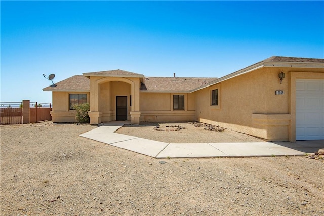 6045 S Klamath Loop, Fort Mohave, AZ 86426 - single story home featuring stucco siding, fence, a garage, and a shingled roof