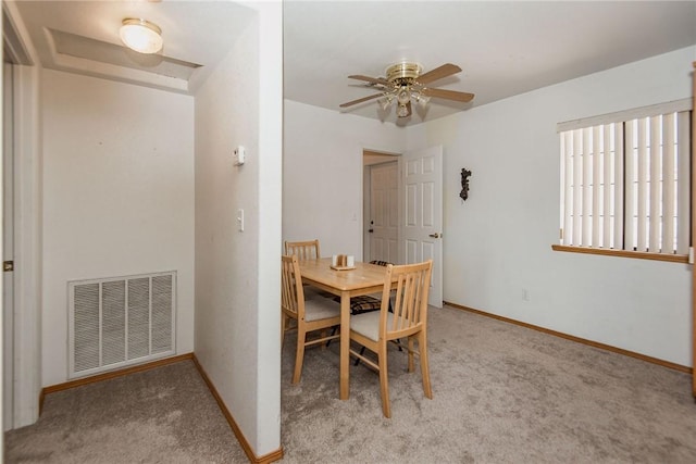 6045 S Klamath Loop, Fort Mohave, AZ 86426 - dining area with light carpet, baseboards, and ceiling fan