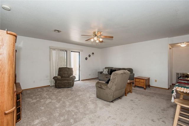6045 S Klamath Loop, Fort Mohave, AZ 86426 - living room featuring a ceiling fan, carpet, and baseboards